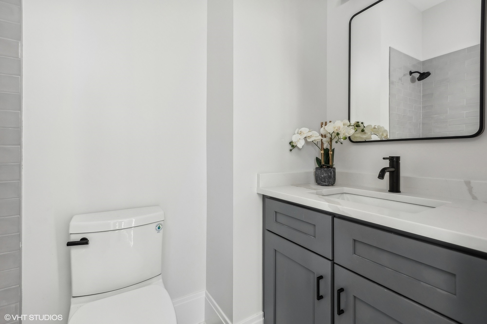 2426 West Augusta Boulevard, Unit 2 Chicago, IL 60622 - Photo 19 of 20 a bathroom with a granite countertop sink and a mirror