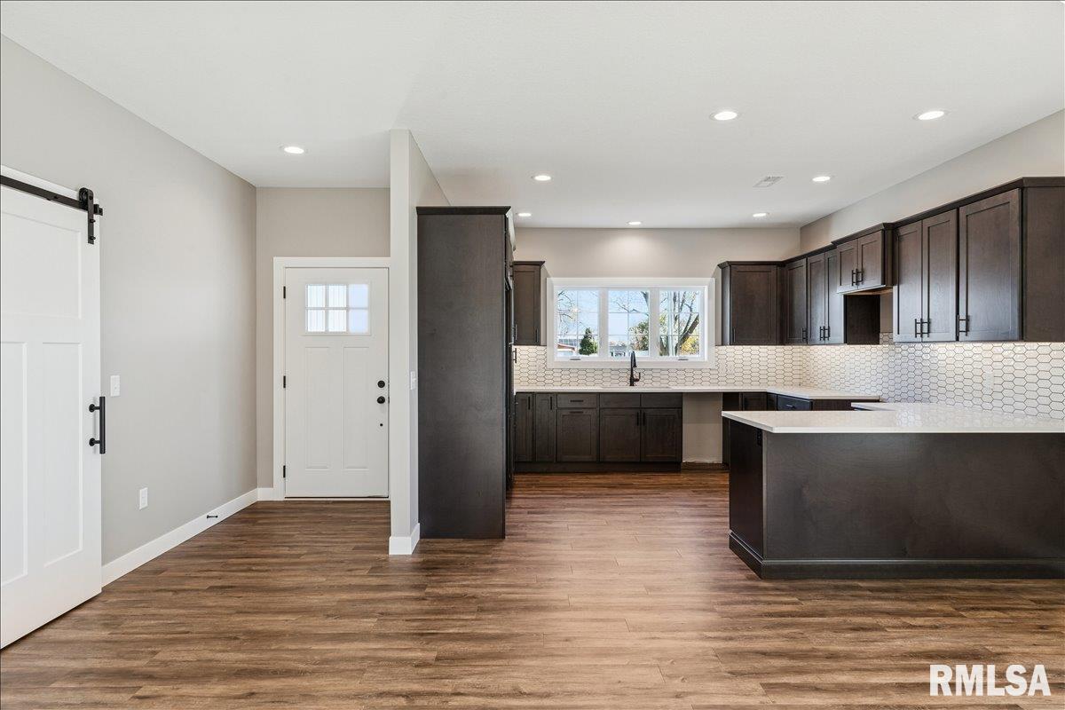 1323 5th Avenue De Witt, IA 52742 - Photo 11 of 28 a kitchen with a sink stainless steel appliances and cabinets