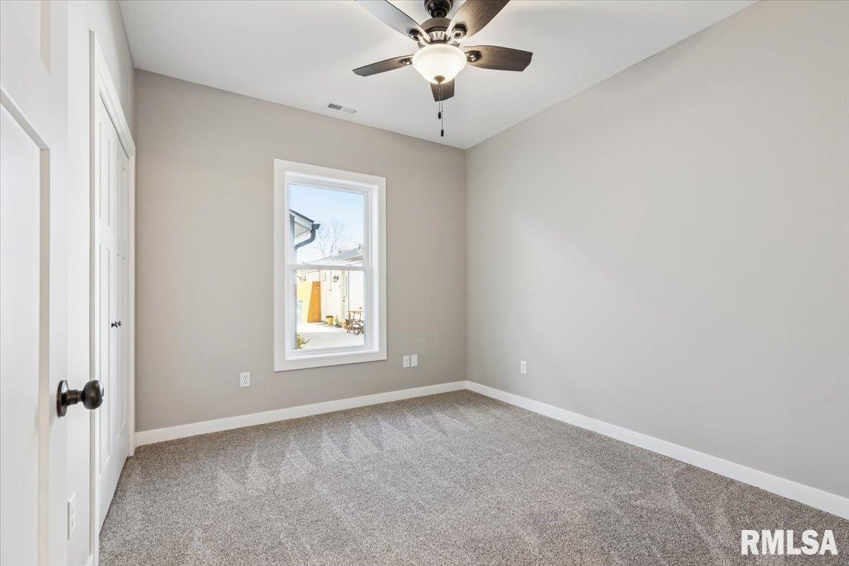 1323 5th Avenue De Witt, IA 52742 - Photo 22 of 28 an empty room with a window and a fan