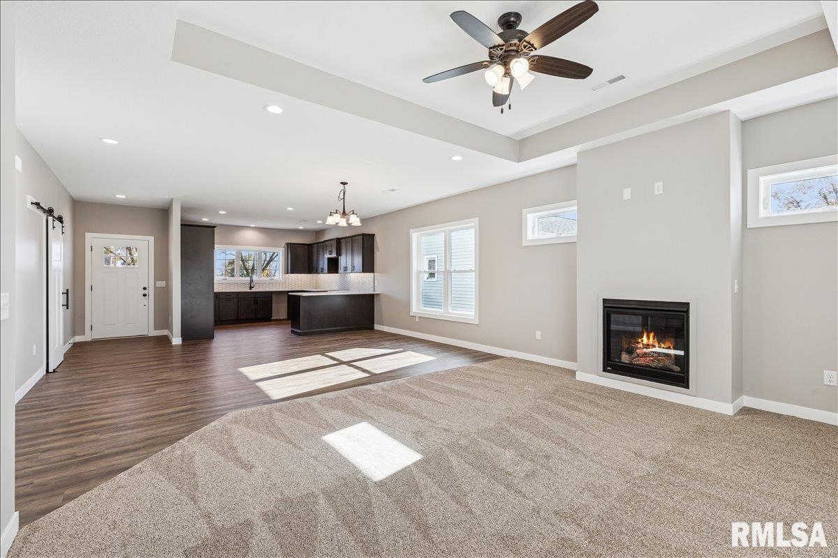 1323 5th Avenue De Witt, IA 52742 - Photo 4 of 28 a view of an empty room with a fireplace and a ceiling fan