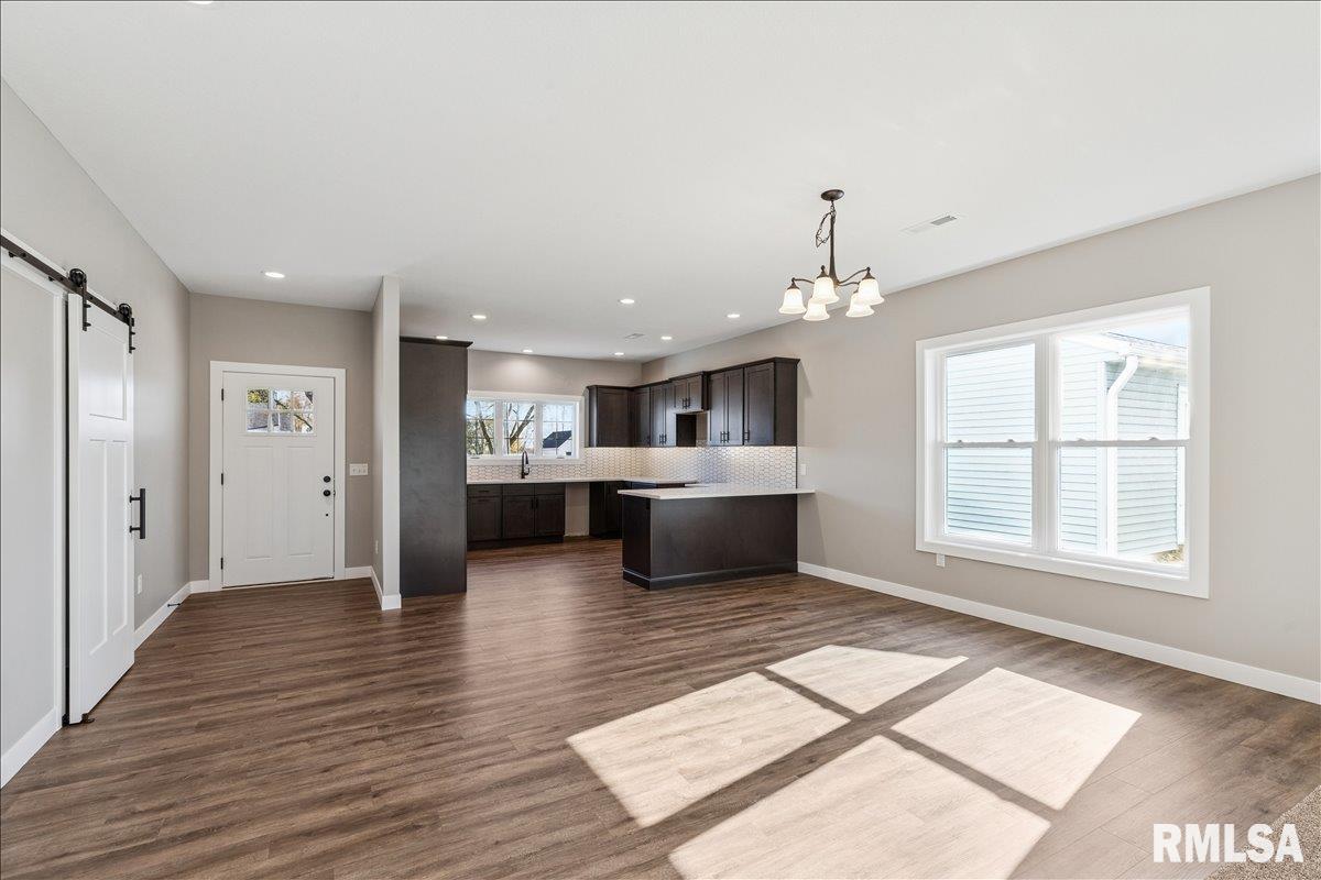 1323 5th Avenue De Witt, IA 52742 - Photo 5 of 28 a large white kitchen with a large window