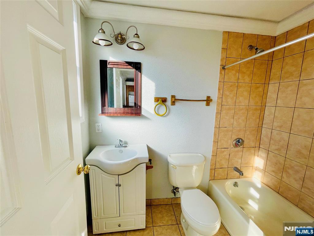 229 Orient Way, Unit 6 Rutherford, NJ 07070 - Photo 7 of 8 a bathroom with a toilet sink and mirror