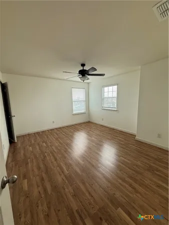 a bathroom with a tub a sink and mirror
