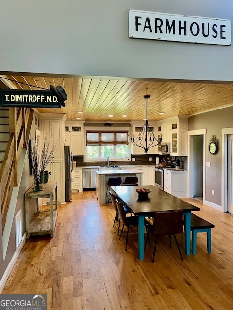 135 Horseshoe Trail Commerce, GA 30529 - Photo 12 of 25 a kitchen with stainless steel appliances kitchen island granite countertop a table and chairs in it