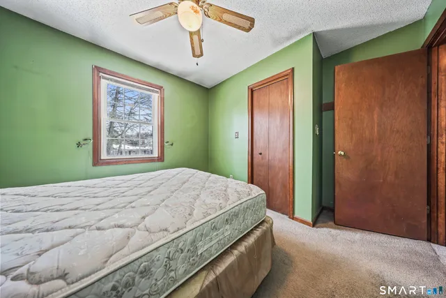 a bedroom with a large bed and a chandelier
