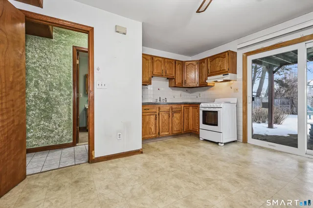 a kitchen with stainless steel appliances granite countertop a sink and a refrigerator