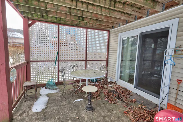 a view of a porch with a table and chairs
