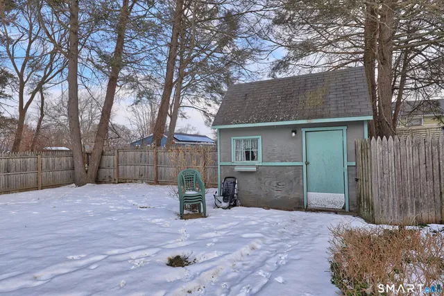 a backyard of a house with table and chairs