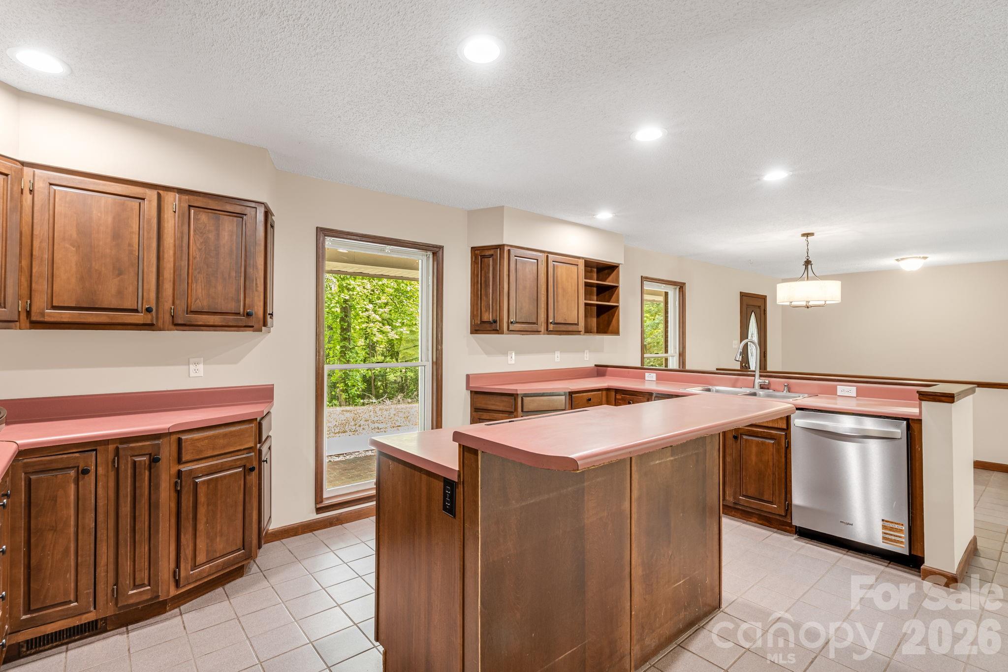 35 Byrd Road Candler, NC 28715 - Photo 16 of 43 a kitchen with stainless steel appliances granite countertop a stove top oven sink and cabinets