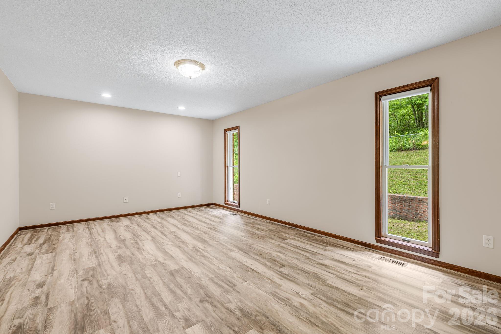 35 Byrd Road Candler, NC 28715 - Photo 25 of 43 a view of an empty room with wooden floor and a window