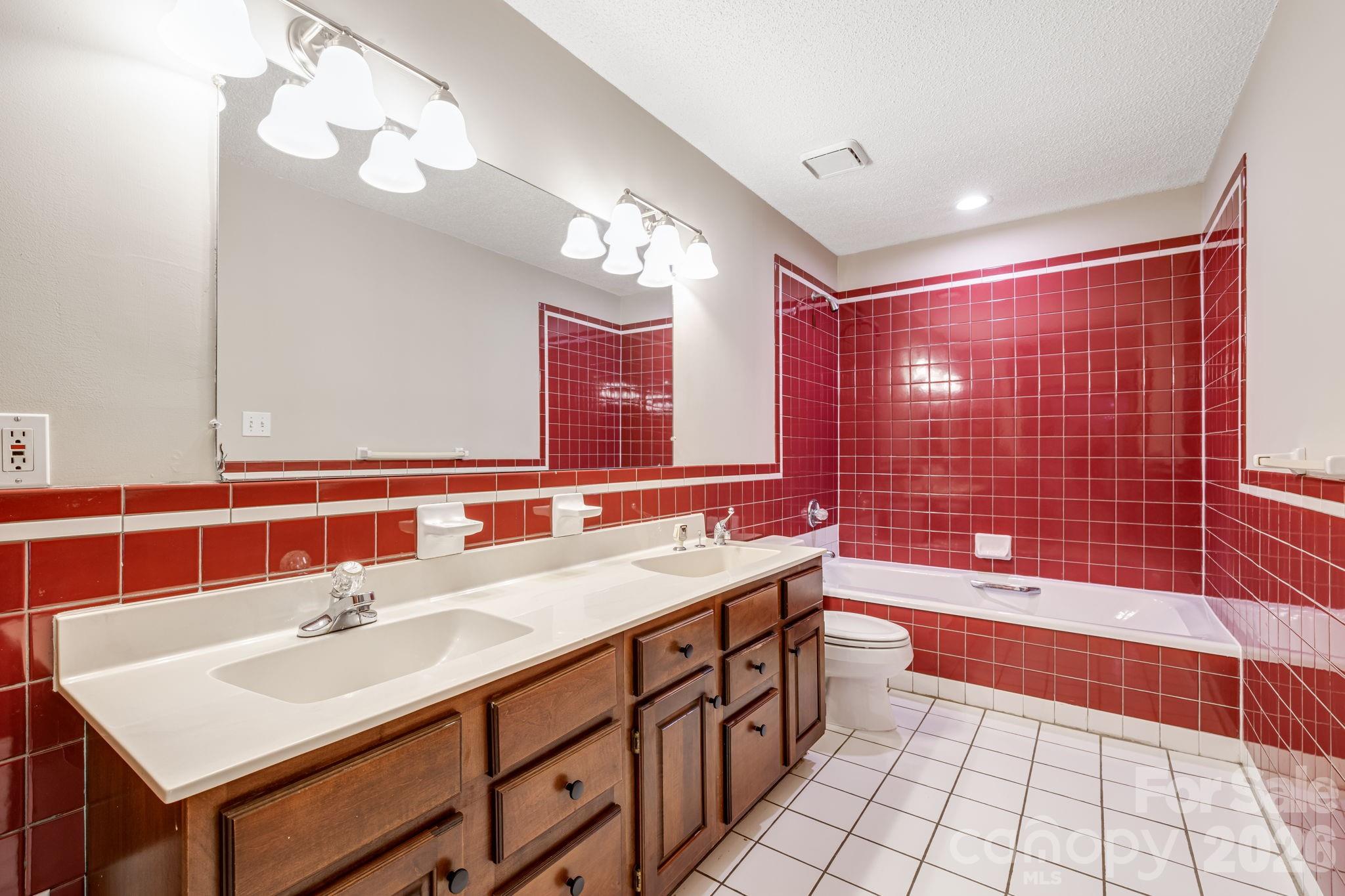 35 Byrd Road Candler, NC 28715 - Photo 28 of 43 a bathroom with a sink a toilet a mirror and shower