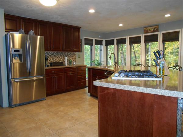 239 Monson Turnpike Road Ware, MA 01082 - Photo 14 of 30 a kitchen with kitchen island a large window cabinets and stainless steel appliances