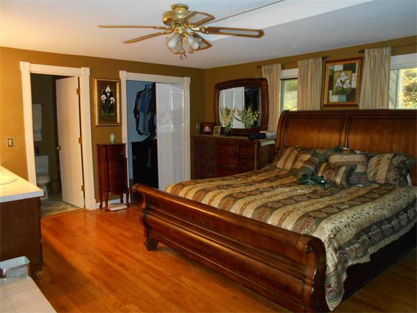 239 Monson Turnpike Road Ware, MA 01082 - Photo 21 of 30 a bed sitting in a spacious bedroom next to a window