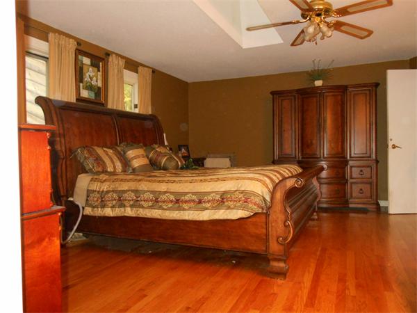239 Monson Turnpike Road Ware, MA 01082 - Photo 23 of 30 a bedroom with a bed and wooden floor