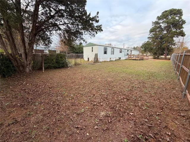 a view of backyard of house with green space
