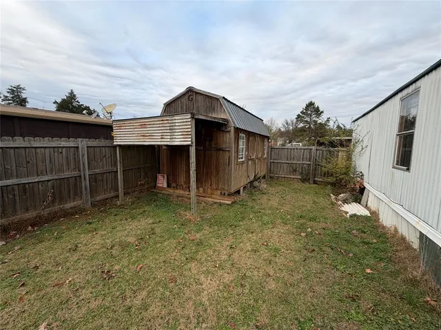 a backyard of a house with a yard and garage
