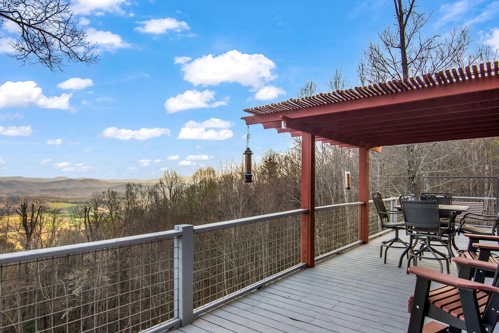 111 Trophy Buck Point Murphy, NC 28906 - Photo 47 of 51 a view of a roof deck with table and chairs a barbeque with wooden floor and fence