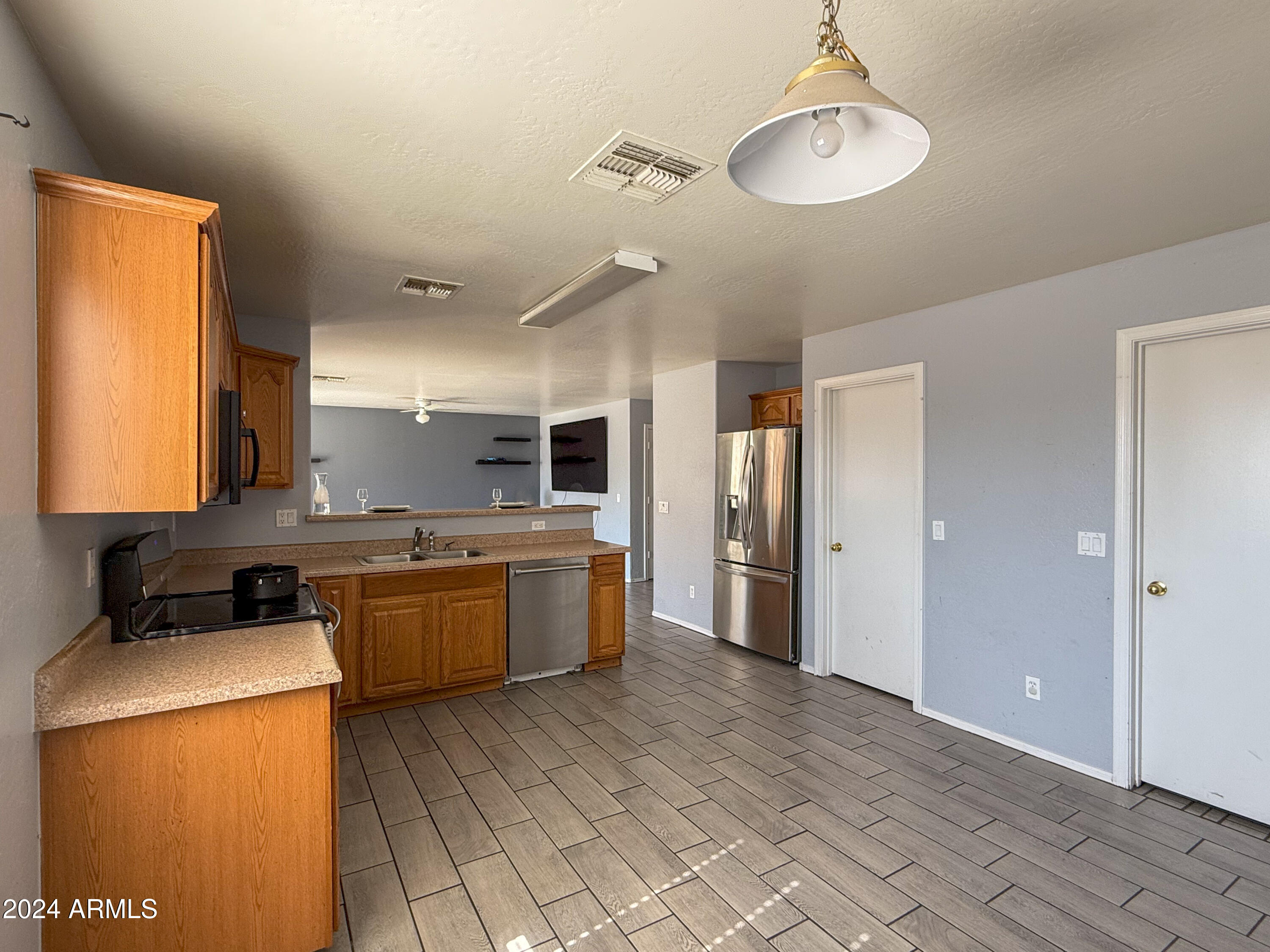 8613 West Riley Road Tolleson, AZ 85353 - Photo 8 of 16 a large kitchen with a large counter top appliances and cabinets