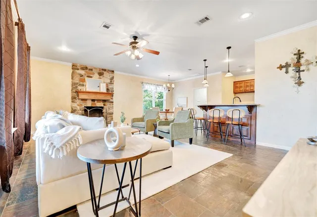 a living room with lots of furniture and view of kitchen