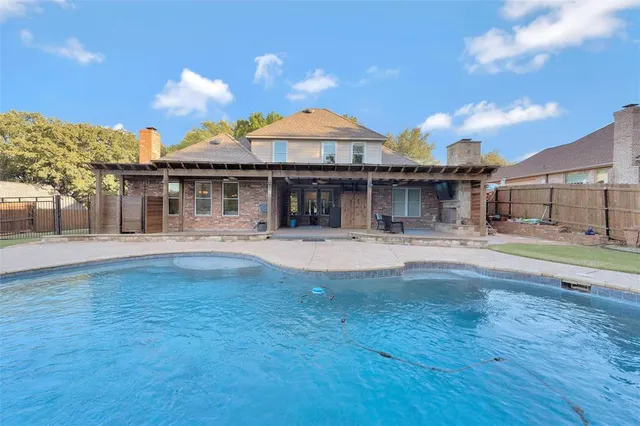 a view of a house with a swimming pool and a yard