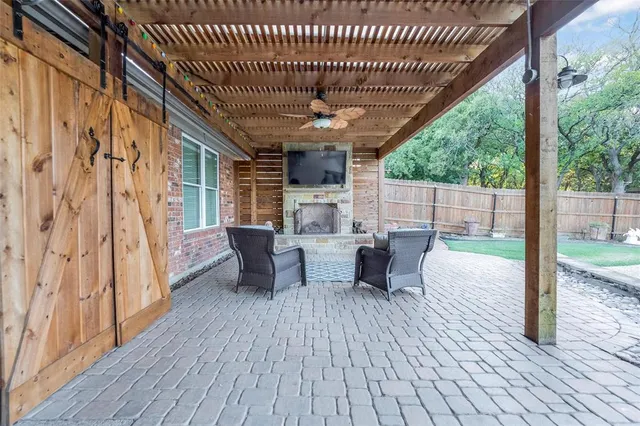a view of a patio with table and chairs