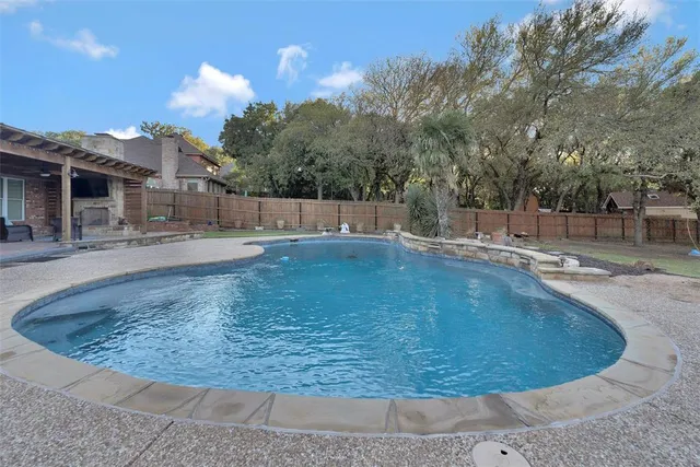 a view of a swimming pool with a yard