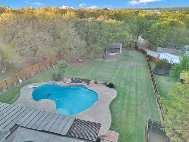 a view of a swimming pool with a yard