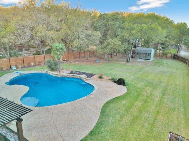 a view of a swimming pool with a yard