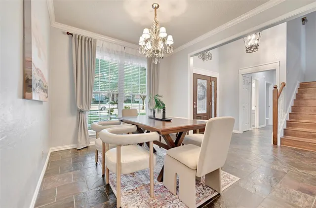 a view of a dining room with furniture wooden floor and a chandelier