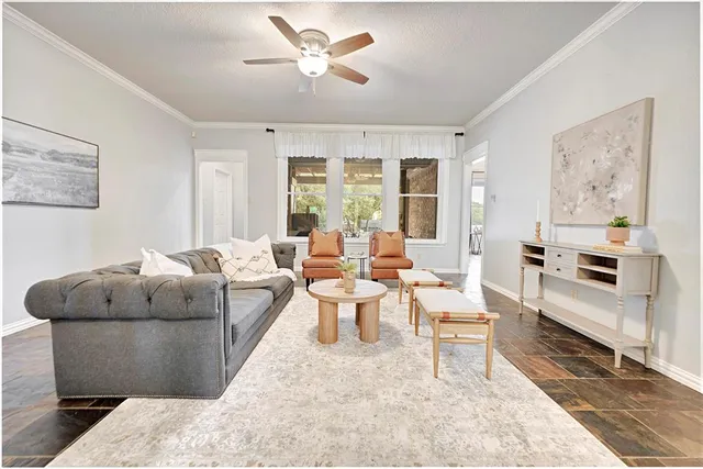 a living room with furniture and a large window