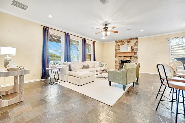 a living room with furniture a dining table and a chandelier
