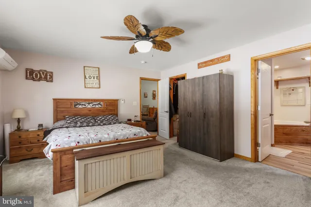 a bedroom with a bed and a large mirror