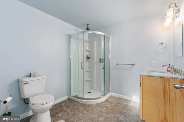 a spacious bathroom with a shower and a sink