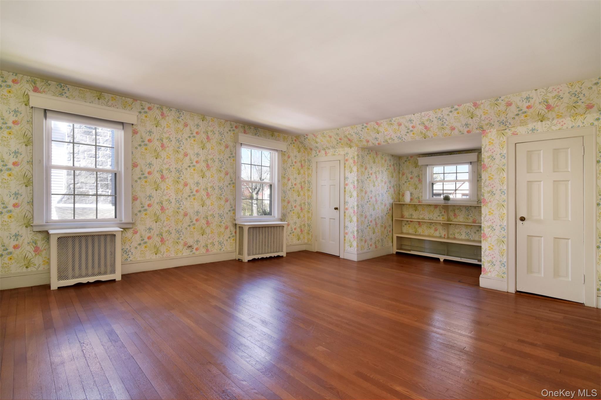 22 Burkewood Road Mount Vernon, NY 10552 - Photo 19 of 27 an empty room with wooden floor and windows