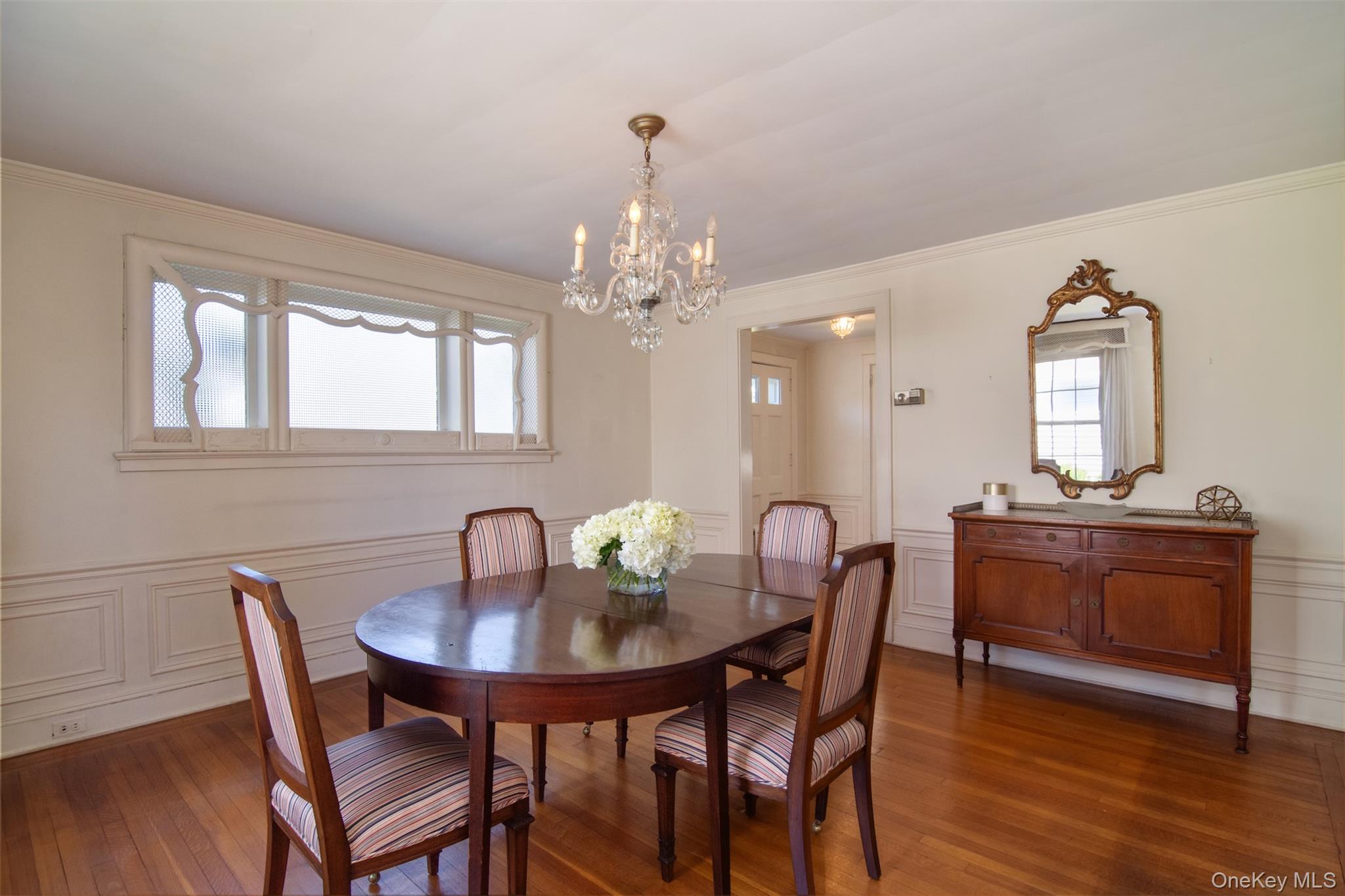 22 Burkewood Road Mount Vernon, NY 10552 - Photo 6 of 27 a dining room with furniture a chandelier and wooden floor