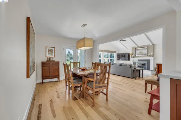 a kitchen with stainless steel appliances granite countertop wooden cabinets a stove a sink and a wooden floors