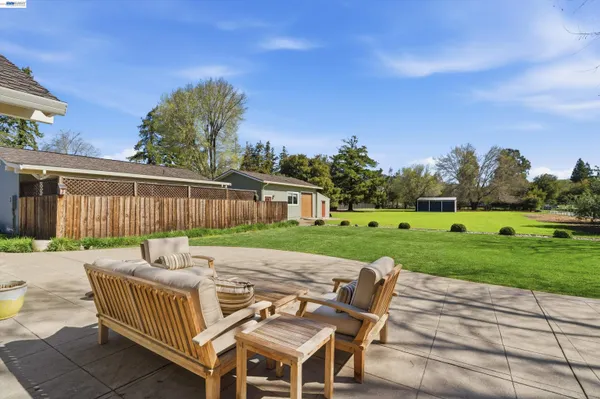 a front view of house with yard and outdoor seating