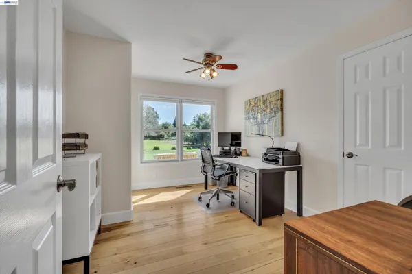 an empty room with windows and closet