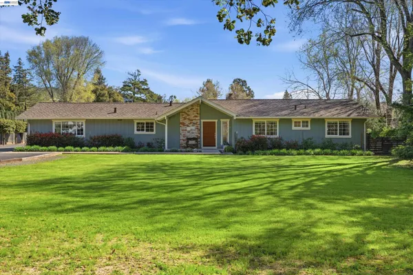 a front view of a house with a garden