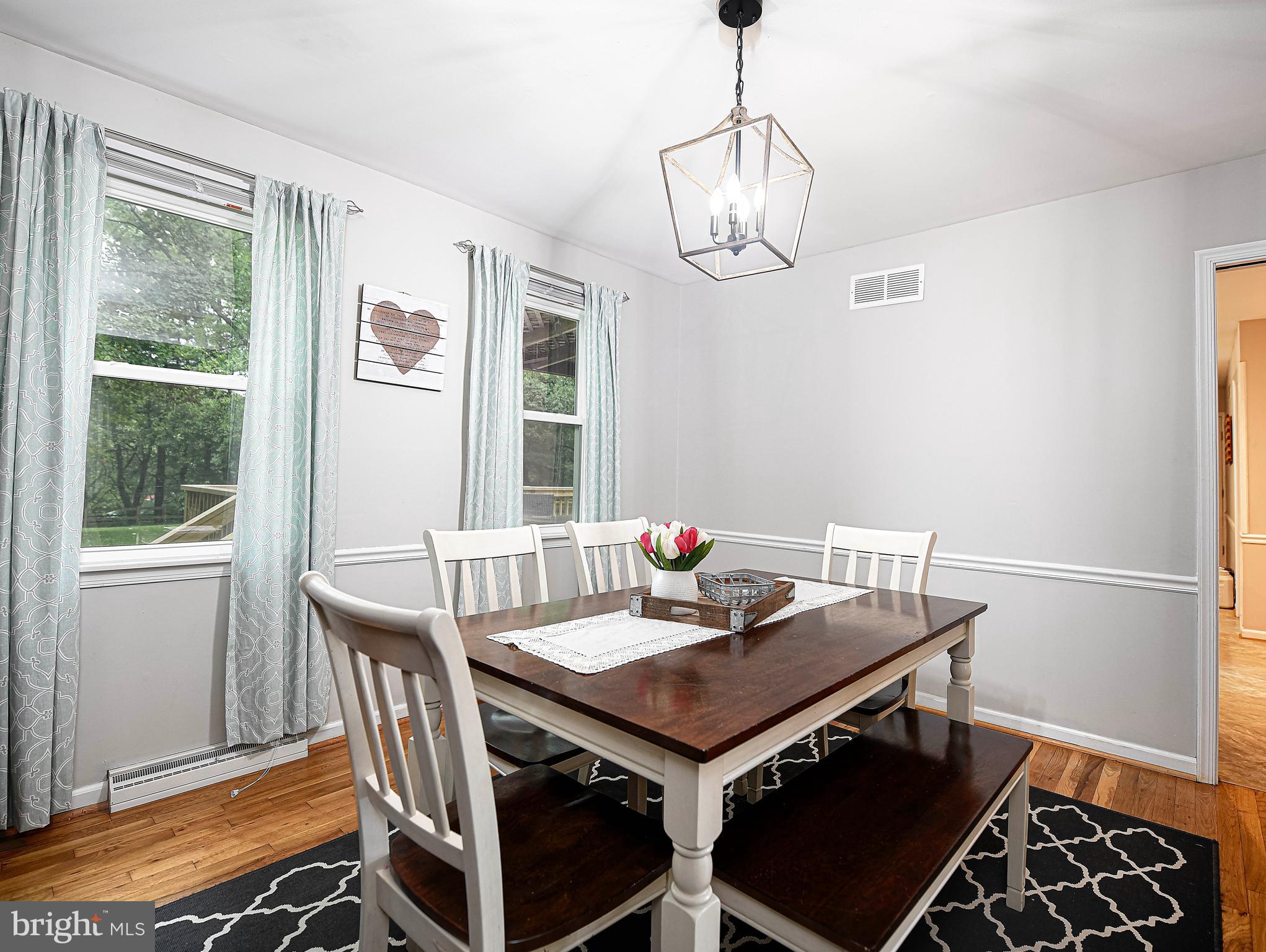 3010 Paper Mill Road Phoenix, MD 21131 - Photo 10 of 35 Chair railing & hardwood floors in dining