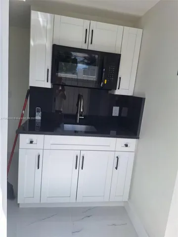 a kitchen with white cabinets