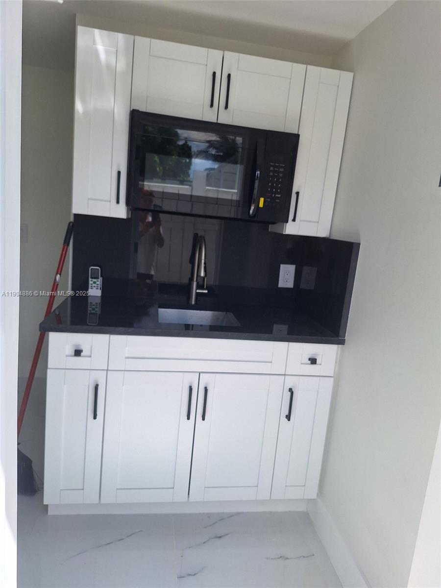 a kitchen with white cabinets