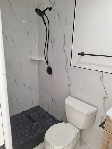 a bathroom with a window and a shower