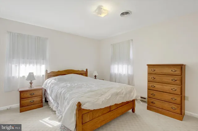 a bedroom with a bed and a dresser