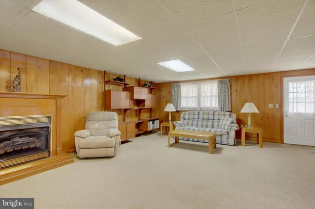 a living room with furniture gym equipment and a fireplace