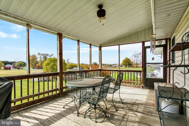 a balcony with furniture and wooden floor