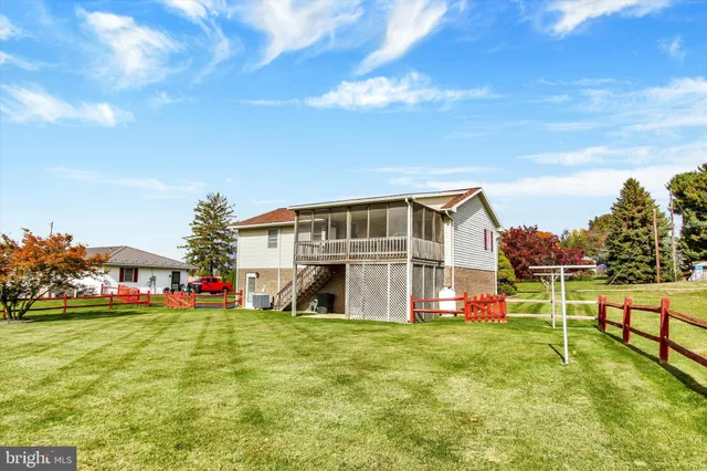 a view of an house with swimming pool garden and trees