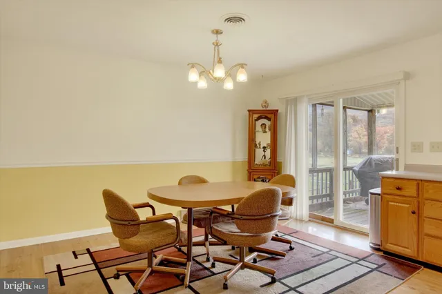a view of a dining room with furniture and a chandelier