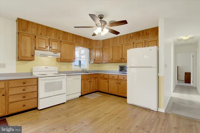 a kitchen with cabinets a refrigerator and a stove
