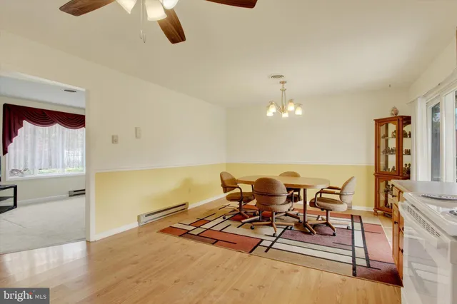a view of a dining room with furniture and chandelier